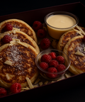 Fluffy gourmet pancakes with fresh raspberries, white chocolate shavings, and dipping sauce. Handmade by Hannah’s Kitchen Cork
