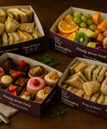 Appetizing catering selection from Hannah’s Kitchen Cork with sandwiches, fresh fruit, and assorted desserts.