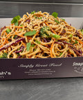 Asian-style noodle salad with broccoli, carrots, red cabbage, and sesame seeds in Hannah’s Kitchen catering tray – fresh Cork catering dish