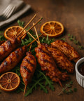 BBQ chicken skewers glazed with rich sauce, served with fresh herbs and orange slices – Hannah’s Kitchen catering Cork.
