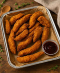 Golden crispy chicken goujons with barbecue dip in foil catering tray from Hannah’s Kitchen Cork.