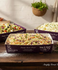 Hannah’s Kitchen salad selection in branded catering boxes – creamy coleslaw, pasta salad with vegetables, and mashed potato, freshly prepared for events in Cork