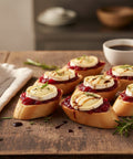 Rustic cranberry and goat’s cheese crostini with fresh herbs on wooden table – festive appetizer from Hannah’s Kitchen Catering Cork