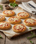 Mini ham and cheese pizza bites topped with melted mozzarella on rustic wooden board – party food by Hannah’s Kitchen Catering Cork