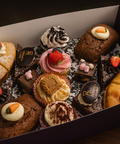 Homemade sweet platter by Hannah’s Kitchen Catering Cork with cupcakes, brownies, mini cakes, and tarts topped with cream and strawberries