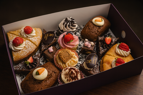Homemade sweet platter by Hannah’s Kitchen Catering Cork with cupcakes, brownies, mini cakes, and tarts topped with cream and strawberries