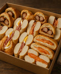 New Yorker breakfast box with bagels, croissants, smoked salmon, sausage and egg from Hannah’s Kitchen Cork.